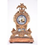 A late 19th century French ormolu and porcelain mantel clock the painted porcelain dial decorated