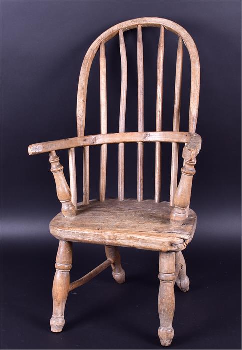 An early 20th century child's Windsor style armchair raised on turned supports, 65cm high x 33cm