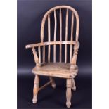 An early 20th century child's Windsor style armchair raised on turned supports, 65cm high x 33cm