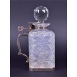 A late Victorian silver-mounted lockable spirit decanter the cut glass body of square form with