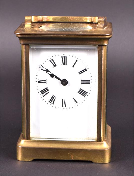 A small late 19th/early 20th century brass carriage clock the white dial with black Roman