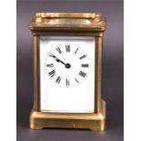 A small late 19th/early 20th century brass carriage clock the white dial with black Roman