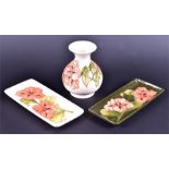 Three items of Moorcroft pottery in the Peach Hibiscus pattern including a small tapered neck vase