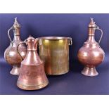 Three large early 20th century Turkish copper flagons the tallest 54cm, together with a brass