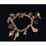 A yellow metal charm bracelet stamped 375, suspended with various gold charms including an