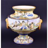 A large Italian maiolica vase in polychrome enamels, depicting a continuous scene of putti and