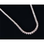 An 18ct white gold and diamond line necklace of graduated round brilliant-cut diamonds of