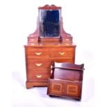 An Edwardian mahogany dressing chest with swivel mirror flanked by two trinket drawers, over two