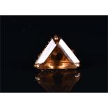 An 18ct yellow gold and smokey quartz ring set with a triangular-cut quartz within a raised three-