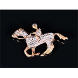 A 9ct yellow gold and diamond horse and jockey brooch set with round brilliant-cut diamonds of