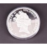 A very large Elizabeth II Soloman Islands 2000 $25 silver coin the reverse with scene of a sailing