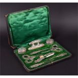 A Victorian cased eleven-piece travelling manicure set all with scrolling pierced handles, set