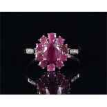 A 9ct white gold and rubellite ring set with an oval cluster of rubellite, the shoulders set with