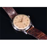 A 1950s Zenith stainless steel mechanical wristwatch the silvered dial with gilt Arabic numerals and