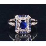 In the Art Deco taste, a diamond and sapphire ring with an emerald cut sapphire surrounded by