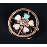 An opal and diamond brooch the openwork circular mount (tests 9 carat gold) with a central brilliant