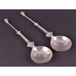 A pair of 19th century Continental silver spoons the broad bowls set before handles decorated with