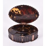 A 19th century tortoiseshell dressing table box of shaped oval form with rose gold-coloured