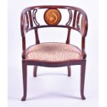 An Art Nouveau mahogany tub chair inlaid with three roundels of fritillaries, padded seat with loose
