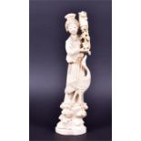A 19th century Japanese carved ivory figure of a Beijin holding flowers in her left hand with a