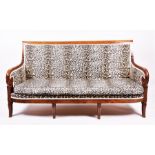 A 19th century and later French mahogany settee with faux leopard skin upholstery, curved back and