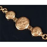 A yellow metal Art Nouveau style bracelet set with three oval segments embossed with images of