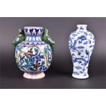 A 20th century Iznik decorated earthenware vase of baluster form, the twin handles formed as