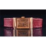 A Boucheron 18ct gold mechanical wristwatch the rectangular case with gilt dial, black markers and