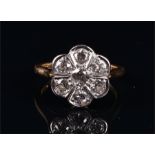 An 18ct gold and diamond cluster ring the daisy cluster totalling approx. 0.80 carat, the shank