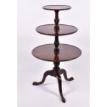 A George III three-tier mahogany dumb waiter  111cm high, the largest tier 65cm diameter, on