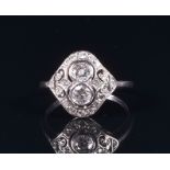 An 18ct white gold and diamond ring in the Art Deco taste, the openwork mount set with two collet