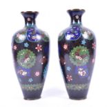 A pair of early 20th century Chinese cloisonne enamelled vases of baluster form with flared rims,