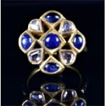 An unusual Eastern style yellow metal, diamond, sapphire, and blue enamel ring the quatrefoil