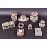 A collection of silver items comprising a hinge lidded card case an inkwell of oval form, a