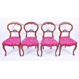 A set of four Victorian yoke back chairs  with red upholstered overstuffed seats on front cabriole