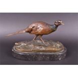 A cold painted bronze pheasant on a naturalistic moorland base, signed in the cast “I Menie”, on