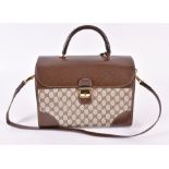 A Vintage Gucci monogrammed travel bag  with leather accents, striped fabric strap and handles,