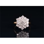 An 18ct yellow gold and diamond cluster ring set with nineteen round brilliant-cut diamonds of