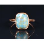 A yellow metal and faux turquoise ring in the antique style, set with a mottled faux turquoise,