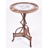 An unusual Aesthetic Movement period bamboo snap-top occasional table with an inset ironstone