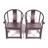 A pair of 20th century or earlier Chinese hardwood horseshoe chairs the swept backs decorated with