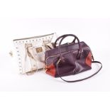 A Tod's leather handbag in aubergine and red with gilt metal mounts, 34cm wide, together with a