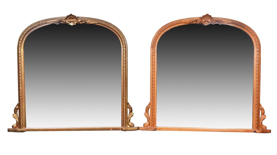 A pair of 20th century wooden overmantle mirrors (one painted), of arched form with stylised