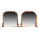 A pair of 20th century wooden overmantle mirrors (one painted), of arched form with stylised