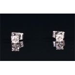 A pair of 18ct white gold and solitaire diamond ear studs set with round brilliant-cut diamonds,