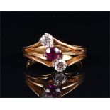 An 18ct yellow gold, diamond and ruby ring the split mount diagonally set with a round-cut ruby