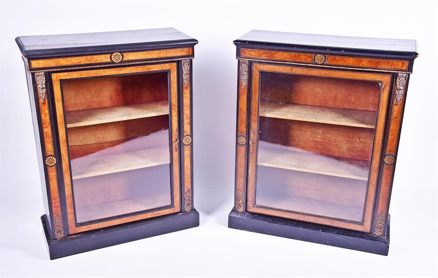 A pair of Victorian ebonised and burr walnut pier cabinets the frieze inlaid with stylised flower