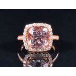 An 18ct rose gold, diamond, and pale lilac gemstone (likely morganite) halo cluster ring set with