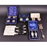 An assortment of silver to include three cased decorative mustards including spoons (eight in