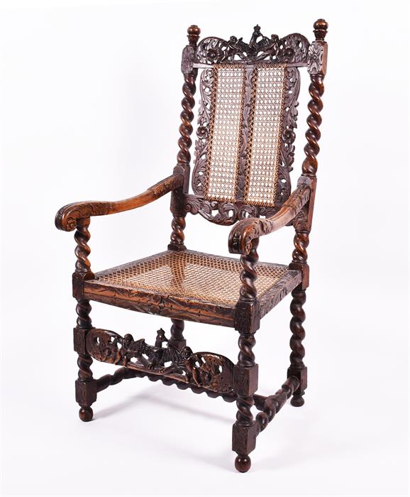 A Charles II style carved walnut armchair with intricately decorated top section depicting